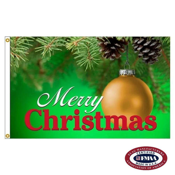 A flag with a golden Christmas ornament. The words "Merry Christmas" are on the bottom in white and red text. The background is green and near the top you can see Christmas tree branches and pinecones. FMAA Made in America seal.