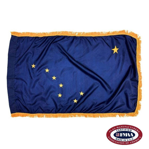 The fringed Alaska flag has 8 gold stars on a dark blue field. 7 of the stars form the Big Dipper, and the 8th star is the North Star.  FMAA Certified Made in America seal.
