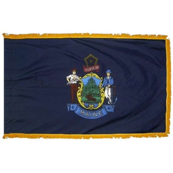 The indoor Maine flag has 3 edges of gold fringe around the dark blue field. In the center is the state seal above a banner reading “Maine.”