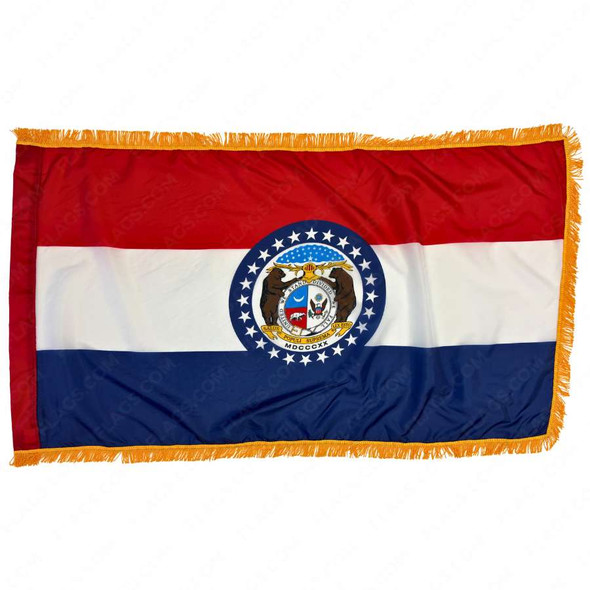 The indoor Missouri flag has 3 sides of gold fringe around the 3 horizontal red, white, and blue stripes. In the center is the state seal.