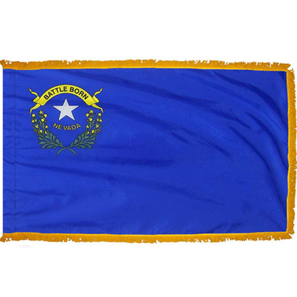 The indoor Nevada flag has 3 sides of gold fringe around the blue field. In the canton are a star, 2 sagebrush branches and the state motto.