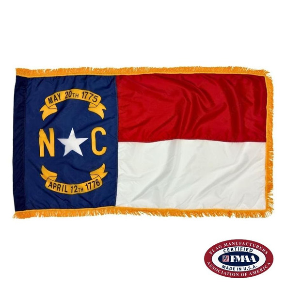 The indoor North Carolina flag has 3 sides of gold fringe around a dark blue field on the left and 2 stripes of red and white on the right. FMAA Certified Made in America seal.