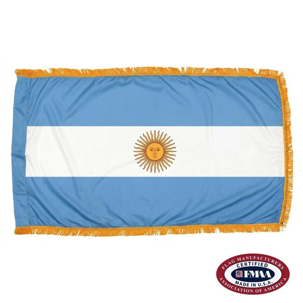The indoor Argentina flag has 3 sides of gold fringe around 3 stripes of blue, white, and blue. In the center is a yellow sun. FMAA Certified Made in America seal.