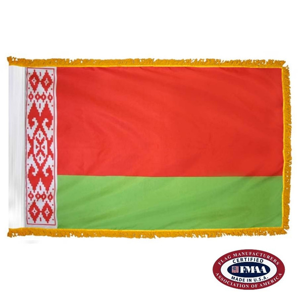 The indoor Belarus flag has 3 sides of gold fringe around a red field with a vertical white stripe on the left & a horizontal green one below. FMAA Certified Made in America seal.