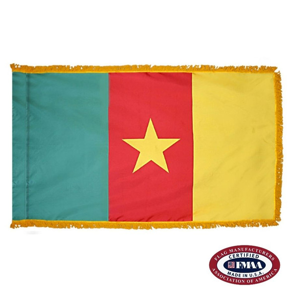 The indoor Cameroon flag has 3 sides of gold fringe around a green, red, and yellow tricolor. In the center is a yellow star. FMAA Certified Made in America seal.