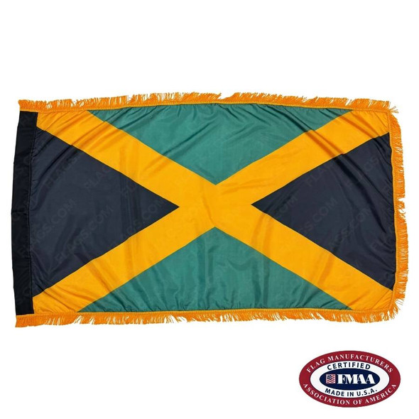 The indoor Jamaica flag has 3 sides of gold fringe around a yellow saltire with green fields above and below and black left and right. FMAA Certified Made in America seal.