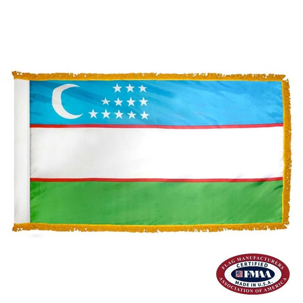 The indoor Uzbekistan flag has 3 sides of gold fringe around a blue, white, and green tricolor. At the top is a white crescent and 12 stars. FMAA Certified Made in America seal.