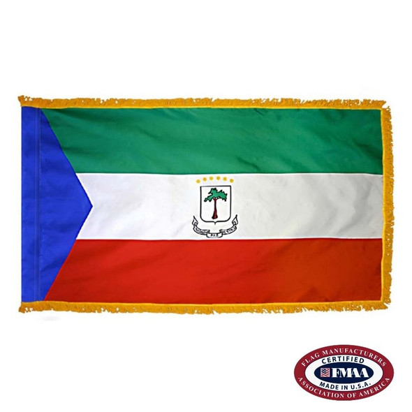 The indoor Equatorial Guinea flag has gold fringe around a green, white & red tricolor with a blue triangle on the left & a seal in the center. FMAA Certified Made in America seal.