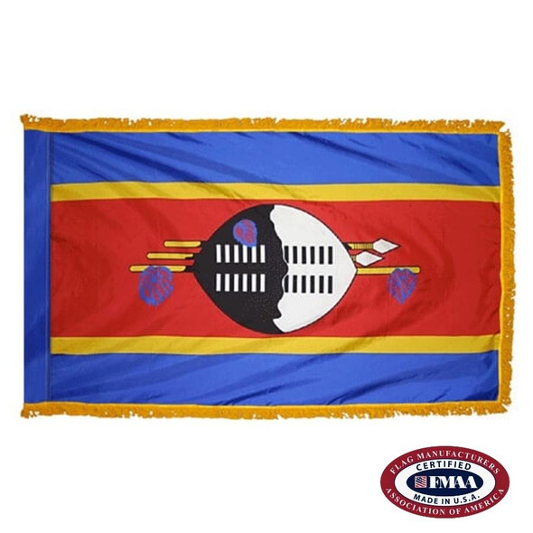 The indoor Eswatini flag has 3 sides of gold fringe around 5 blue, yellow, and red stripes. In the center is a black and white shield. FMAA Certified Made in America seal.