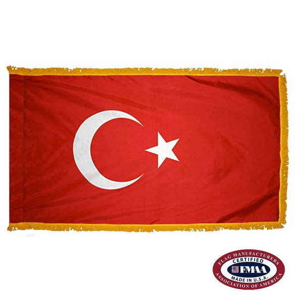 The indoor Turkey flag has 3 sides of gold fringe around a red field with a white crescent and a 5-pointed star. FMAA Certified Made in America seal.