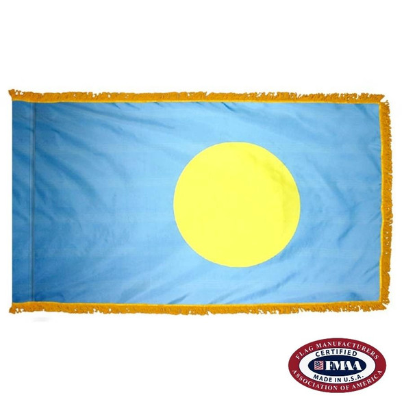 The indoor Palau flag has 3 sides of gold fringe around a light blue field with a large yellow circle off-center to the right. FMAA Certified Made in America seal.