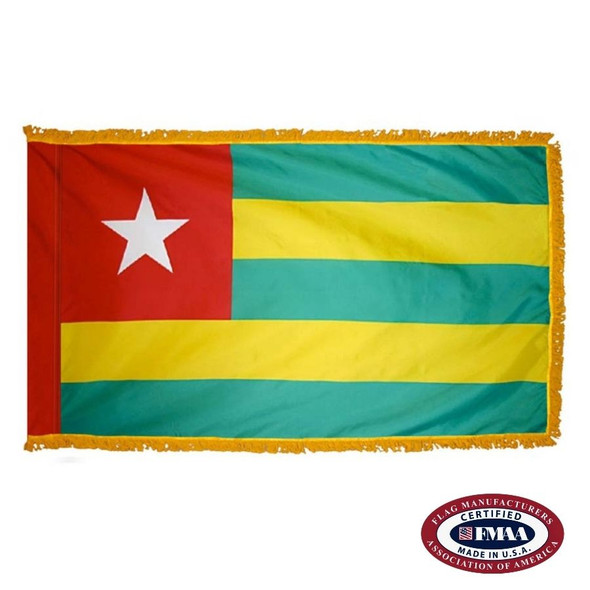 The indoor Togo flag has 3 sides of gold fringe around 5 horizontal green and yellow stripes. There is a white star in the red canton. FMAA Certified Made in America seal.