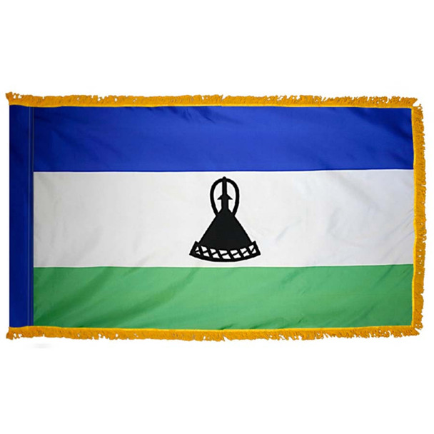 The indoor Lesotho flag is a horizontal blue, white, and green tricolor. In the center of the wider white stripe is a black mokorotlo.