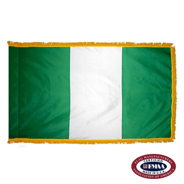 The indoor Nigeria flag has 3 sides of gold fringe around a vertical green and white triband. FMAA Certified Made in America seal.