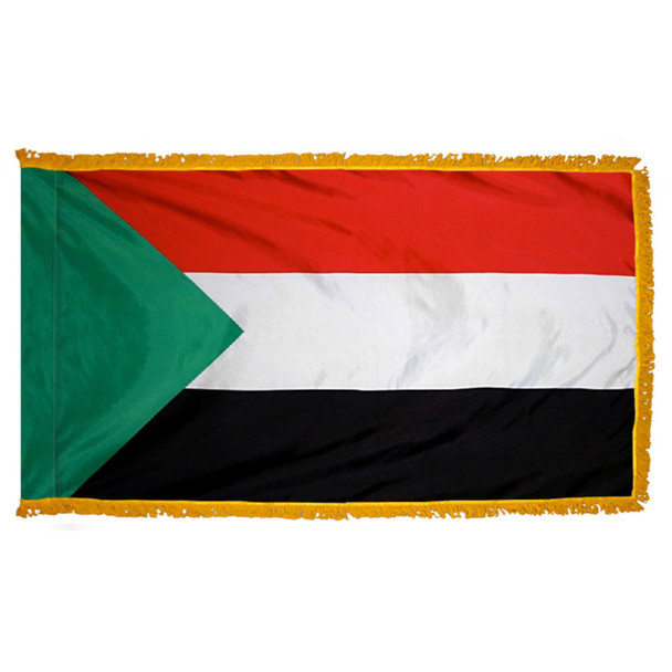 The indoor Sudan flag has 3 sides of gold fringe around a horizontal red, white, and black tricolor. On the left is a green triangle.