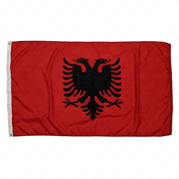 The Albania flag featuring a red field and a a silhouetted black double-headed eagle in the middle.