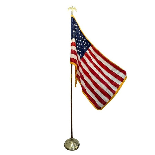A US flag with gold fringe is displayed on an upright oak pole and floor stand. An eagle ornament is placed at the top of the pole.