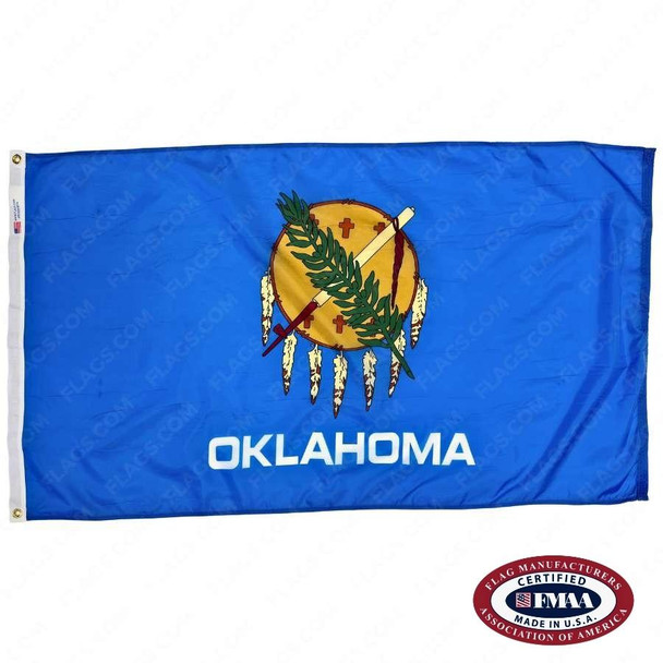 The blue Oklahoma flag has an Osage shield in the center, adorned with feathers, a calumet, & an olive branch. The text “Oklahoma” is below. FMAA Certified Made in America seal.