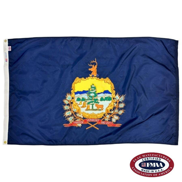 The dark blue Vermont flag has a seal in the center, depicting a cow and hay under a tree. A banner reads “Vermont / Freedom and Unity”. FMAA Certified Made in America seal.