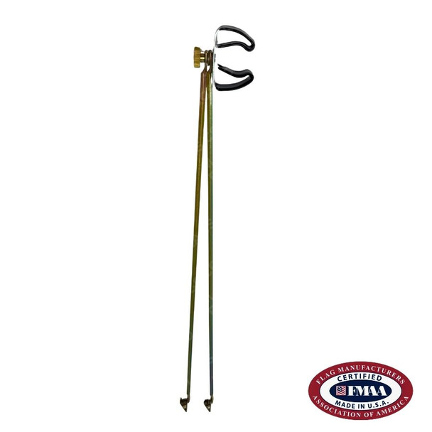 A gold-colored flag spreader with two long tines pointing downward with a small clip on each end.