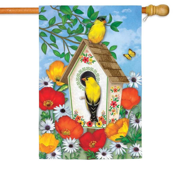 A house flag depicting two yellow finches perched on a white birdhouse, surrounded by colorful flowers.