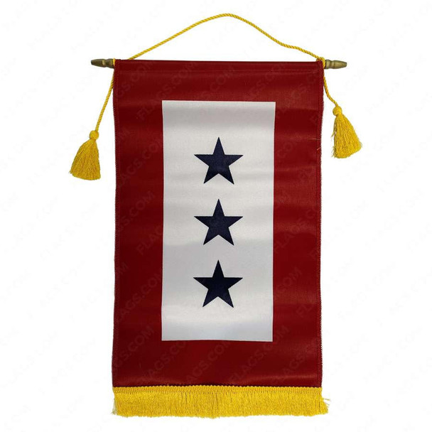 A 3 star in service banner with gold fringe on the bottom. This banner hangs vertically with a red field. The center has a large vertical white rectangle with 3 navy stars in the middle. 