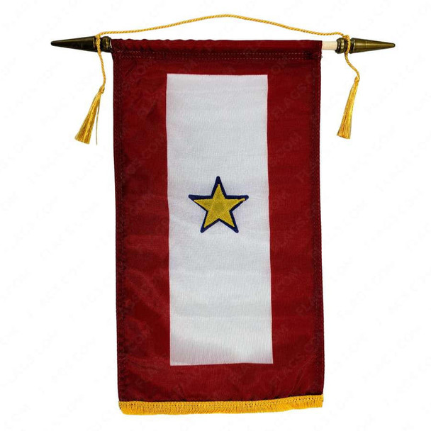 A gold star in service banner with gold fringe on the bottom. This banner hangs vertically with a red field. The center has a large vertical white rectangle with a yellow star in the middle. 