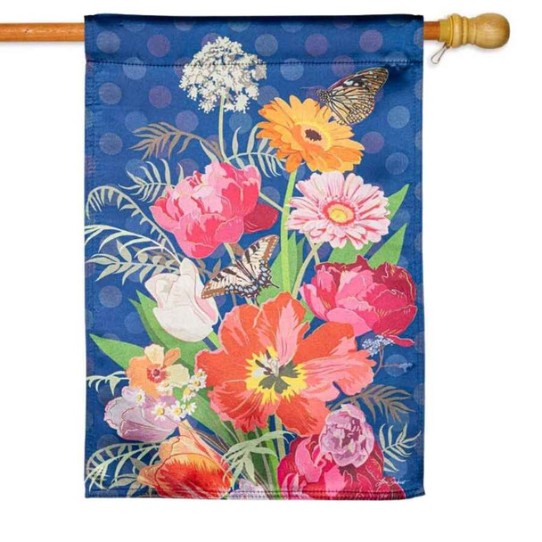 The Bloom Boldly Lustre House Flag is dark blue with a bouquet of colorful flowers in the center.