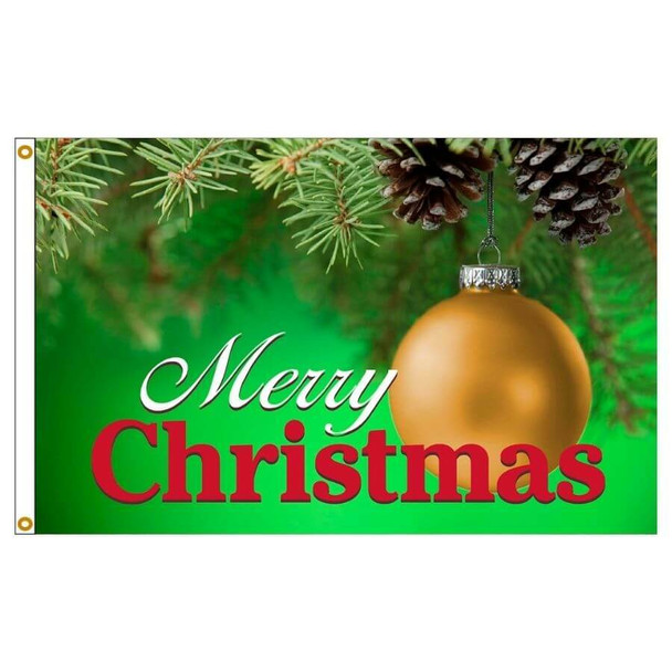 A flag with a golden Christmas ornament. The words "Merry Christmas" are on the bottom in white and red text. The background is green and near the top you can see Christmas tree branches and pinecones.