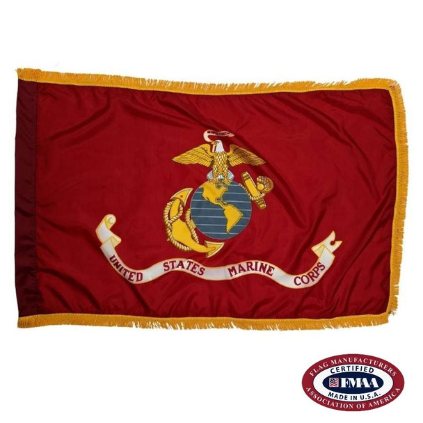 The indoor Marine Corps flag has a red background lined on 3 sides with gold fringe. In the center is an emblem with a globe, eagle, and anchor.