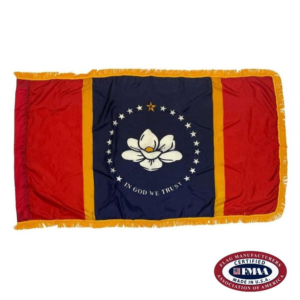 The indoor Mississippi flag has 3 sides of gold fringe around the red & blue tricolor. In the center is a white magnolia circled by stars. FMAA Certified Made in America seal.