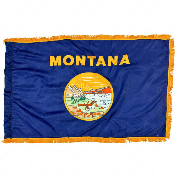 The indoor Montana flag has 3 sides of gold fringe around the dark blue field. In the center is the state name in gold above the state seal.