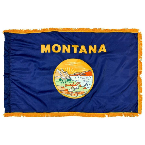 The indoor Montana flag has 3 sides of gold fringe around the dark blue field. In the center is the state name in gold above the state seal.
