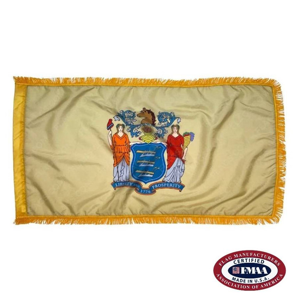 The indoor New Jersey flag has 3 edges of gold fringe around the beige field. In the center is a seal, with 2 people flanking a blue shield. FMAA Certified Made in America seal.