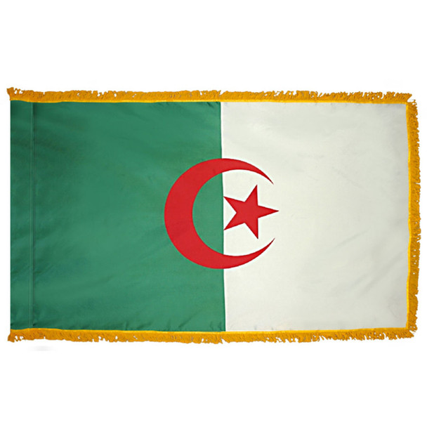 The indoor Algeria flag has 3 sides of gold fringe around 2 fields of green and white. In the center is a red crescent with a star inside.