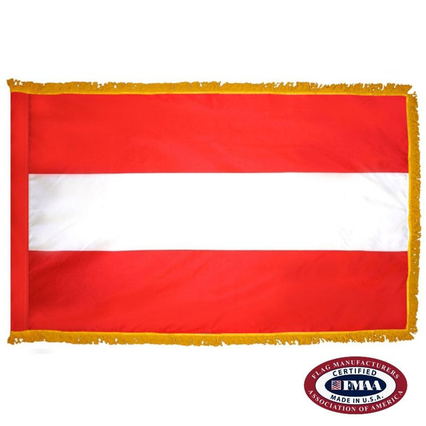 The indoor Austria flag has 3 sides of gold fringe around the 3 red, white, and red horizontal stripes. FMAA Certified Made in America seal.
