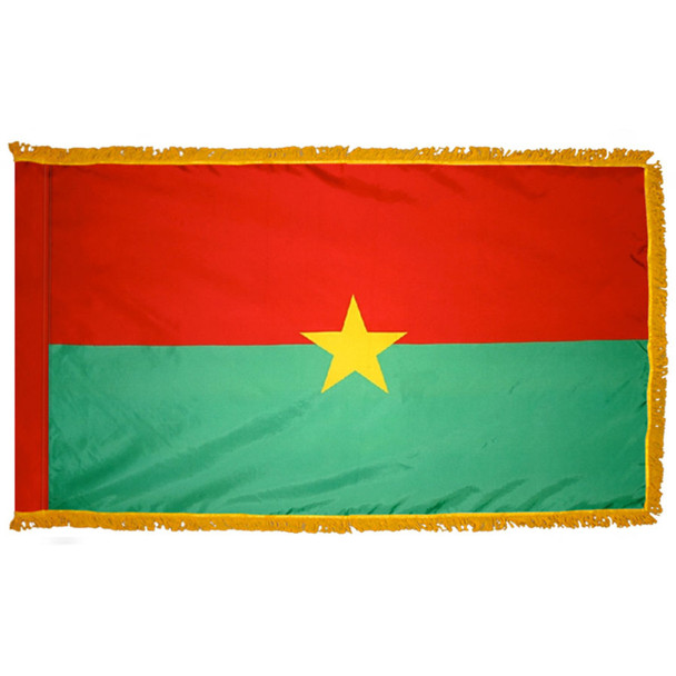 The indoor Burkina Faso flag has 3 sides of gold fringe around the two horizontal stripes of red and green. In the center is a yellow star.