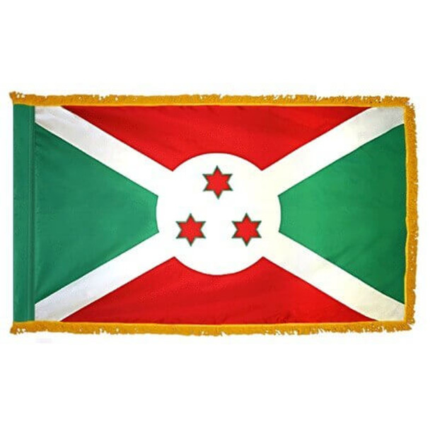 The indoor Burundi flag has 3 sides of gold fringe around a red and green saltire with a white cross & 3 stars in the center.