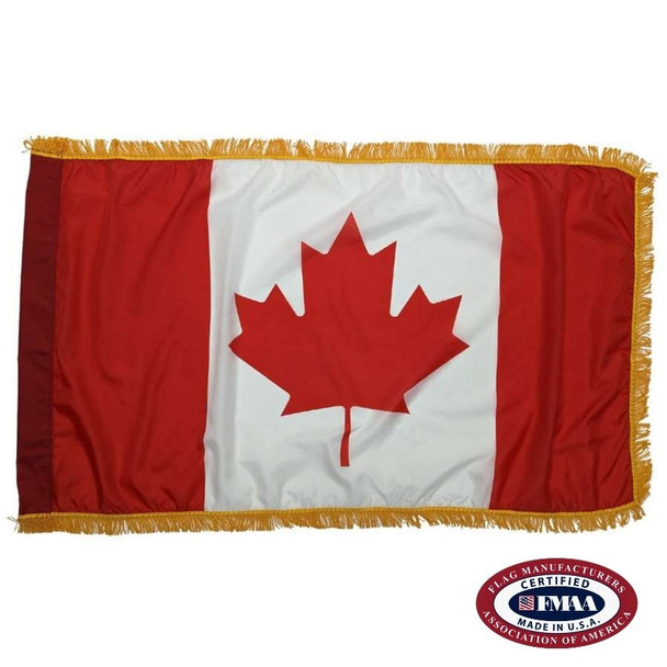 The indoor Canada flag has 3 sides of gold fringe around the red, white, and red triband design. In the white stripe is a red maple leaf. FMAA Certified Made in America seal.