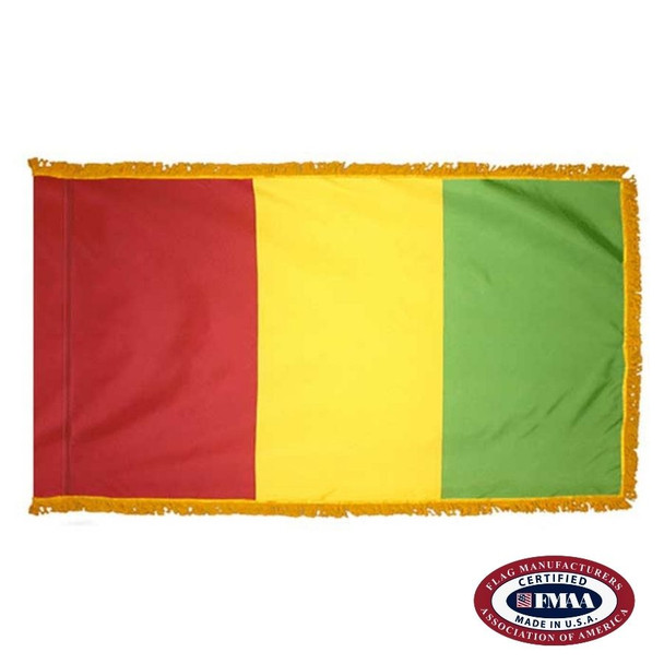 The indoor Guinea flag has 3 sides of gold fringe around a vertical red, yellow, and green tricolor. FMAA Certified Made in America seal.