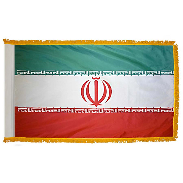 The indoor Iran flag has 3 sides of gold fringe around a green, white, and red tricolor with the national emblem in the center.