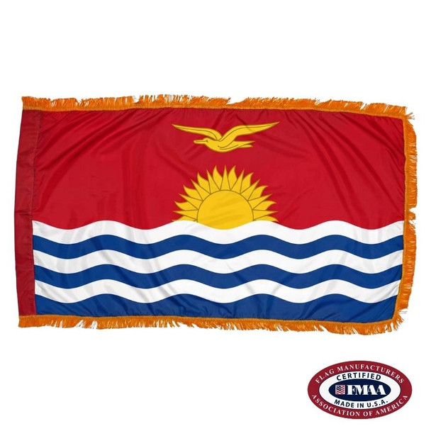 The indoor Kiribati flag has 3 sides of gold fringe around a red field depicting a bird flying over the sun and ocean. FMAA Certified Made in America seal.