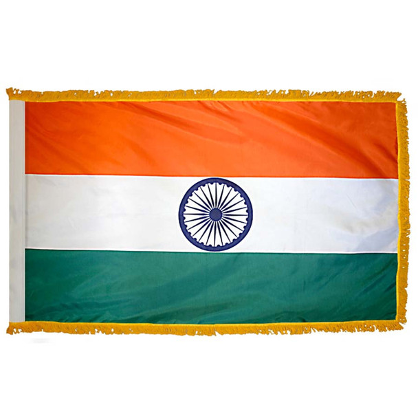 The indoor India flag has 3 sides of gold fringe around a horizontal orange, white, and green tricolor. In the center is the Ashoka Chakra.