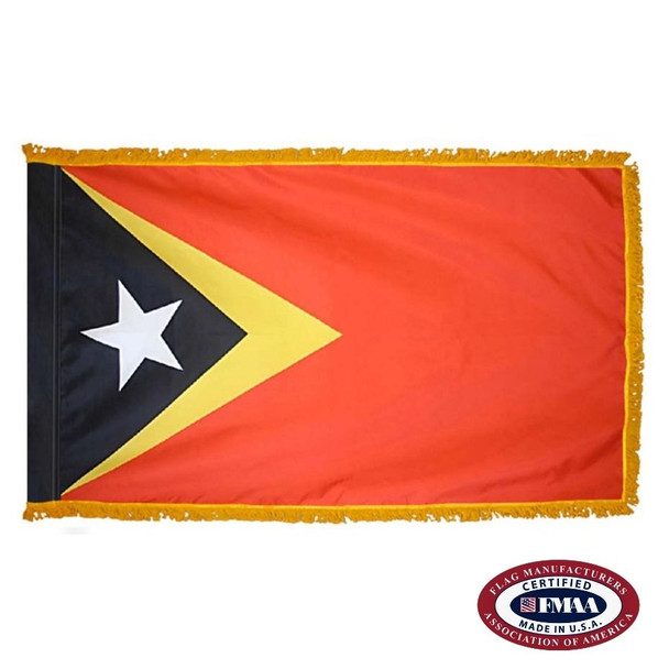 The indoor East Timor flag is red with a black triangle on the left inside a larger yellow triangle. Inside the black one is a white star. FMAA Certified Made in America seal.