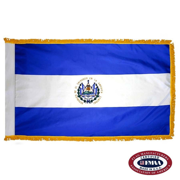 The indoor El Salvador flag has 3 sides of gold fringe around the horizontal triband of blue, white, and blue. In the center is a seal. FMAA Certified Made in America seal.