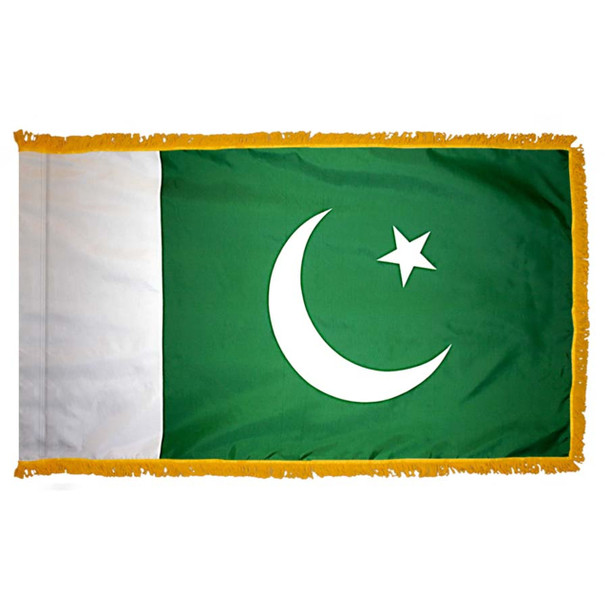 The indoor Pakistan flag has 3 sides of gold fringe around a green field with a white field on the left and a crescent & star on the right.
