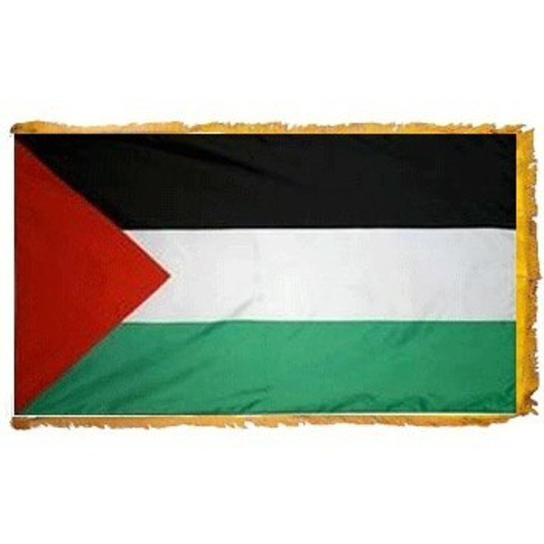 The indoor Palestine flag has 3 sides of gold fringe around a horizontal black, white, and green tricolor. On the left is a red triangle.