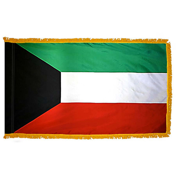 The indoor Kuwait flag has 3 sides of gold fringe around a horizontal green, white, and red tricolor. On the left is a black trapezium.
