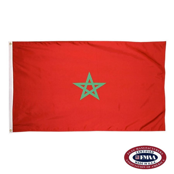 The indoor Morocco flag has 3 sides of gold fringe around a red field with a green star in the center. FMAA Certified Made in America seal.