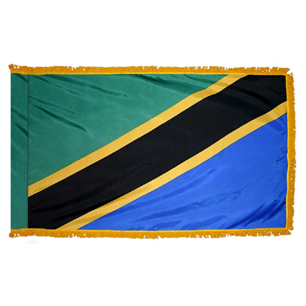 The indoor Tanzania flag has 3 sides of gold fringe around 2 green and blue triangles separated by a black line with gold outlines.